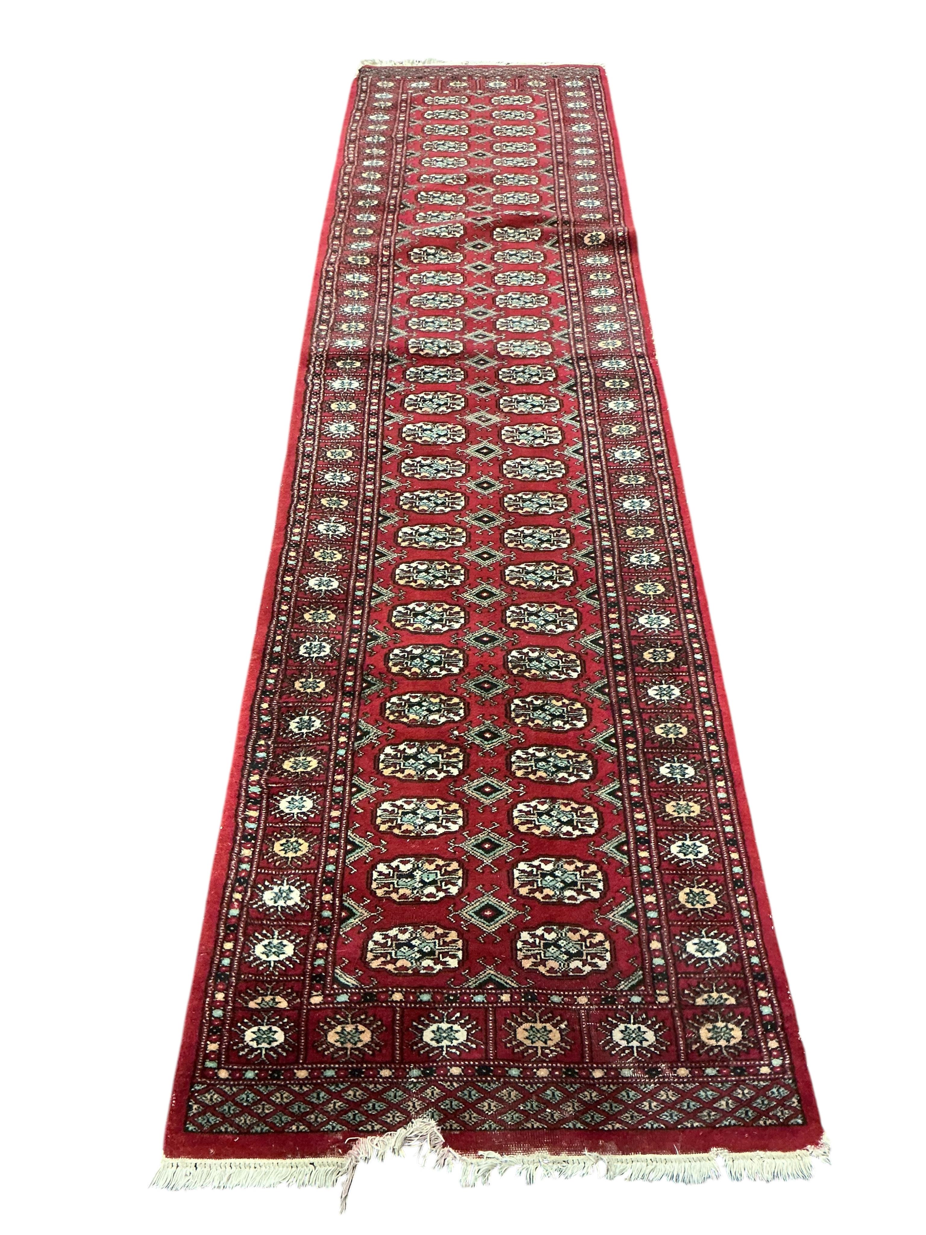 A Bokhara red ground runner and smaller rug, larger 300 x 78cm